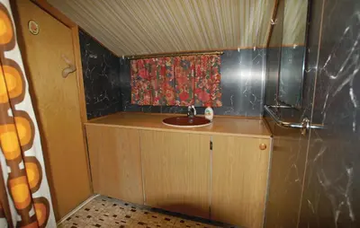 a small bathroom with a sink and a shower at Petterbua in Norheimsund