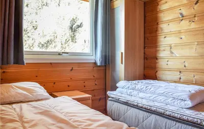 a bedroom with two beds and a window at Stunning Home In Os With Kitchen in Oma