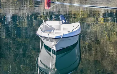 a small boat sitting in the water at Stunning Home In Os With Kitchen in Oma