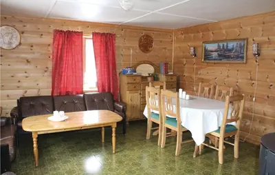 a dining room with a table and a table and chairs at Holiday Home Evanger Brekkhuslii in Evanger