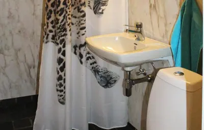 a bathroom with a sink and a shower curtain at Holiday Home Evanger Brekkhuslii in Evanger