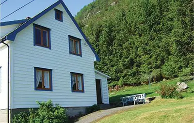 a white house with a bench in front of it at Holiday Home Sørbøvåg Sandnes in Sandnes