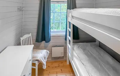a bedroom with two bunk beds and a window at Cozy Home In Lavik With House Sea View in Lavik