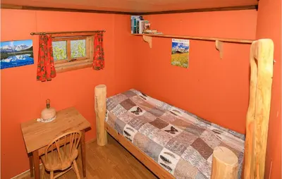 a bedroom with a bed and a table and a window at 2 Bedroom Beautiful Home In Balestrand in Balestrand