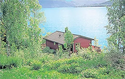 a house on the shore of a large body of water at Holiday Home Balestrand Stokkebø Ii in Balestrand