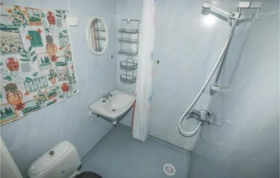 a bathroom with a shower and a toilet and a sink at Holiday Home Balestrand Stokkebø Ii in Balestrand