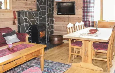 a living room with a table and a wood stove at Stunning Home In Vik I Sogn With Wifi in Espeset