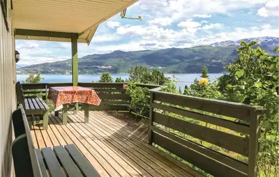a wooden deck with a table and bench on a house at Holiday Home Balestrand Stokkabø in Balestrand