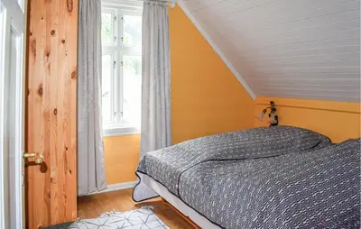 a bedroom with a bed and a window at Nice Home In Vik I Sogn With Jacuzzi in Åse