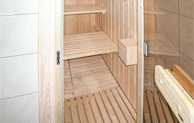 a small wooden sauna with a bench in it at Stunning Home In Sogndal With Sauna in Sogndal