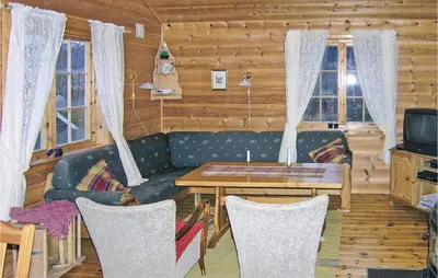 a living room with a couch and a table at Beautiful Home In Skei I Jølster in Årdal