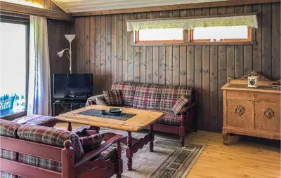 a living room with a table and a couch at Gorgeous Home In Ålfoten With Sauna in Ålfoten