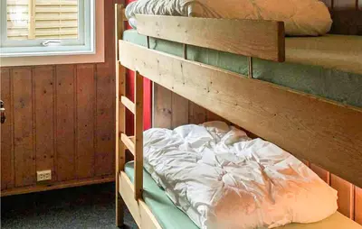 a couple of bunk beds in a room at Gorgeous Home In Ålfoten With Sauna in Ålfoten