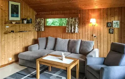 a living room with a couch and two chairs and a table at Flåten Hyttegrend in Olden