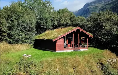 a small house with a grass roof on a field at Flåten Hyttegrend in Olden