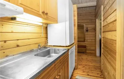 a kitchen with a sink and wooden cabinets at Beautiful Home In Olden With Sauna in Olden