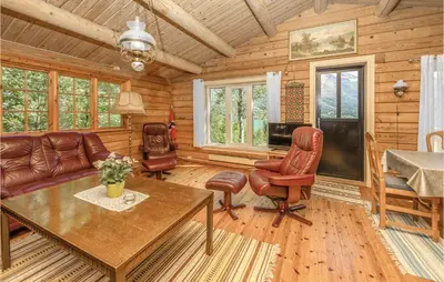 a living room with a couch and a table and chairs at Beautiful Home In Olden With Sauna in Olden