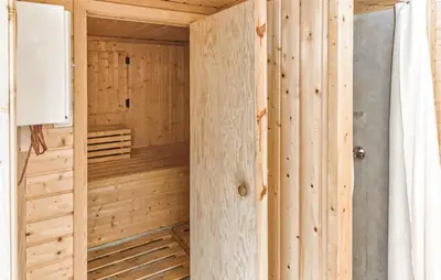 a wooden cabin with a sauna in a room at Glomnes Nr 2 in Hjelle