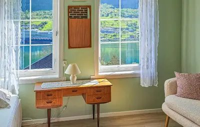 a bedroom with a desk and two windows at Amazing Home In Olden With Wifi in Olden