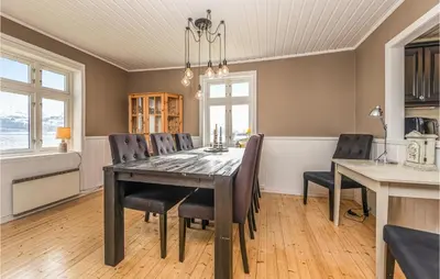 a dining room with a table and chairs at Holiday Home Kvamsøy Storholmen in Sandvik