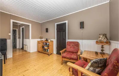 a living room with a couch and a table at Holiday Home Kvamsøy Storholmen in Sandvik