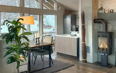 a kitchen with a table and a wood stove at Stunning Home In Stranda With Sauna in Stranda