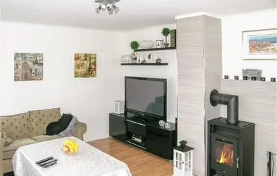 a living room with a fireplace and a tv at Sandshamn in Sandshamn