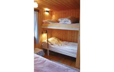 a room with two bunk beds in a cabin at Holiday Home Isfjorden Isfjorden in Isfjorden