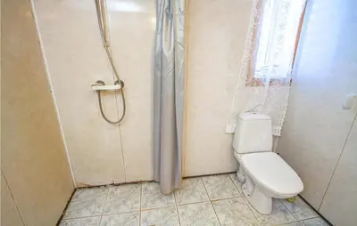 a bathroom with a shower and a toilet at Holiday Home Vågstranda Hjelvik Ii in Hjelvik