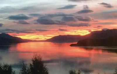 a sunset over a large body of water at Lovely Home In Vågstranda in Hjelvik