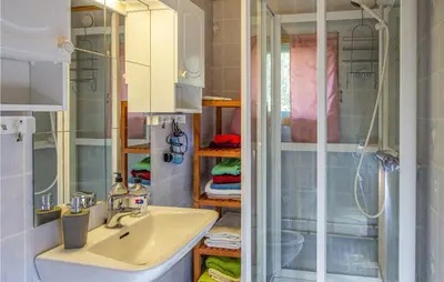 a bathroom with a sink and a shower at Holiday Home Farstad Rævhaugen in Farstad