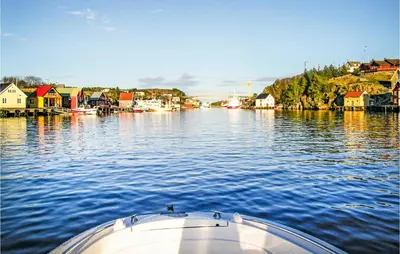 a boat in a body of water with houses at Evastua in Averoy