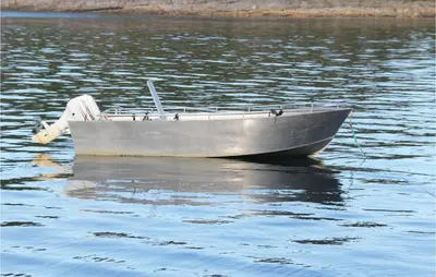 a small silver boat floating on a body of water at 4 Bedroom Lovely Home In Kvisvik in Kvisvik