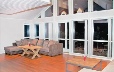 a living room with a couch and a table at 4 Bedroom Lovely Home In Kvisvik in Kvisvik