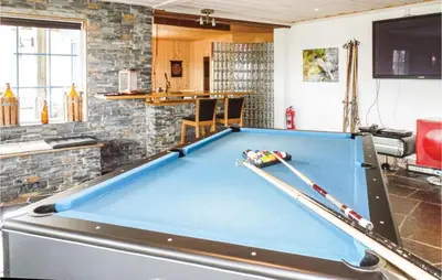 a pool table in a living room with a bill at Amazing Home In Trysil With Sauna in Trysil