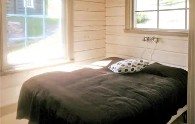 a bed with a pillow in a room with a window at Amazing Home In Trysil With Sauna in Trysil