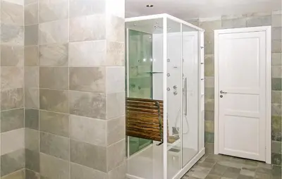 a bathroom with a shower with a glass door at Amazing Home In Trysil With Sauna in Trysil