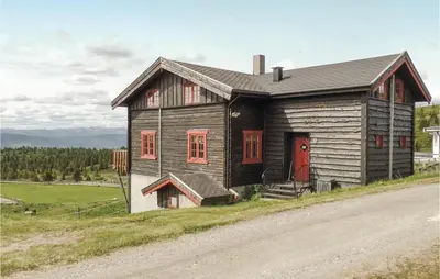 a small wooden house on the side of a road at Storhytta in Vinstra