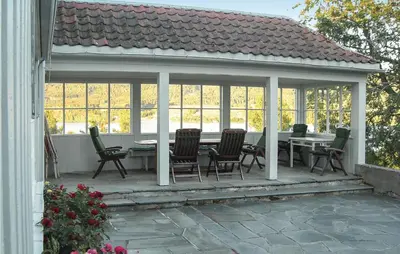 a pavilion with a table and chairs on a patio at 3 Bedroom Amazing Home In Vestsida in Fall
