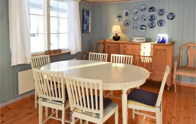 a dining room with a white table and chairs at 3 Bedroom Amazing Home In Vestsida in Fall