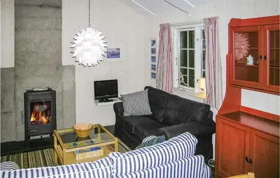a living room with a couch and a fireplace at Holiday Home Gålå Peer Gyntlia in Gålå