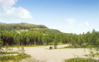 a dirt road with a mountain in the background at Holiday Home Gålå Peer Gyntlia Ii in Gålå