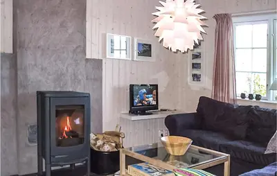a living room with a couch and a fireplace at Holiday Home Gålå Peer Gyntlia Iii in Gålå