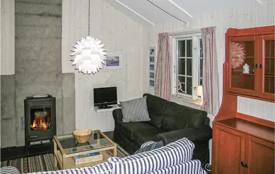 a living room with a couch and a fireplace at Holiday Home Gålå Peer Gyntlia Iii in Gålå