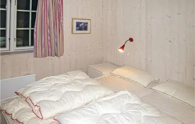 a bed with white sheets and a lamp in a room at Holiday Home Gålå Peer Gyntlia Iv in Gålå