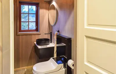 a small bathroom with a toilet and a window at Holiday Home Sjusjøen Tyrily in Sjusjøen