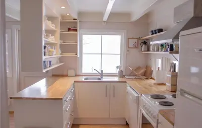 a kitchen with white cabinets and a sink and a window at Lovely Home In Vestsida With Wifi in Fall