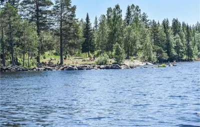 a view of a river with people on the shore at Holiday Home Hunndal Skumlivegen
