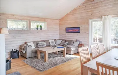a living room with a couch and a table at Amazing Home In Hol With Sauna in Hol