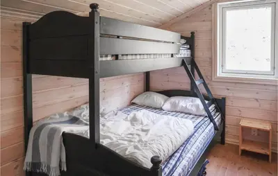 a bedroom with a bunk bed in a cabin at Amazing Home In Hol With Sauna in Hol